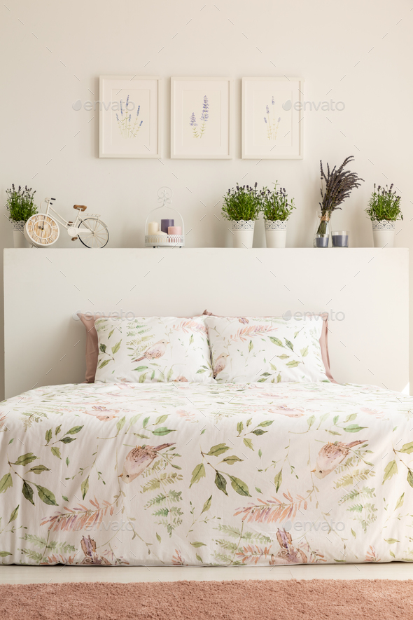 Real photo of floral bedroom interior with a double bed, pillows Stock Photo by bialasiewicz