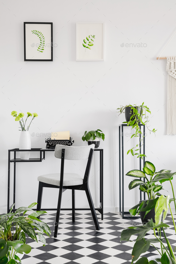 Botanical home office interior with a desk, chair and graphics o Stock Photo by bialasiewicz