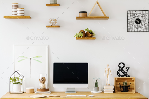 Poster and desktop computer on wooden desk in white home office Stock Photo by bialasiewicz