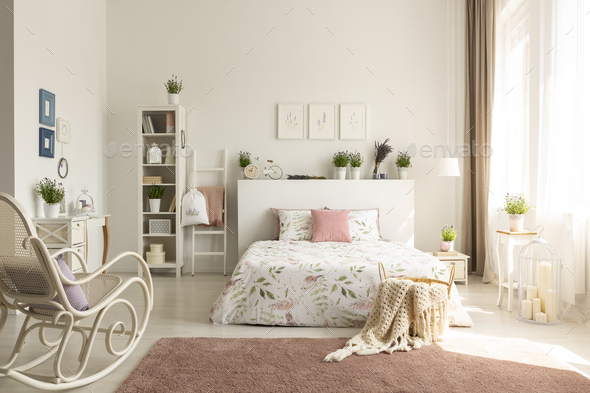 White bedroom interior with dirty pink carpet, rocking chair, wi Stock Photo by bialasiewicz