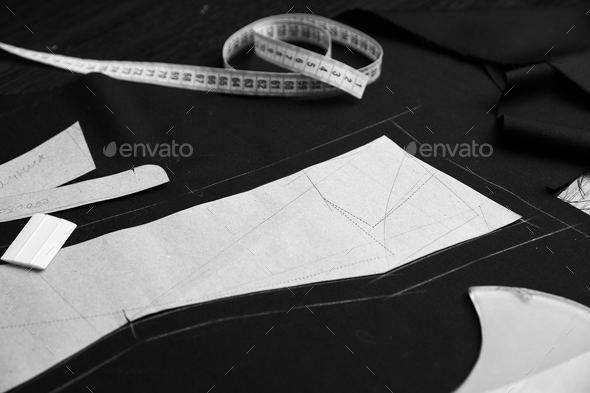 Professional tailor tools set - paper templets, choke, measure tape and scissors on marked fabric Stock Photo by lenina11only