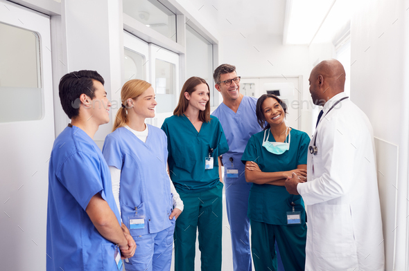 Multi Cultural Medical Team Having Meeting In Hospital Corridor Stock