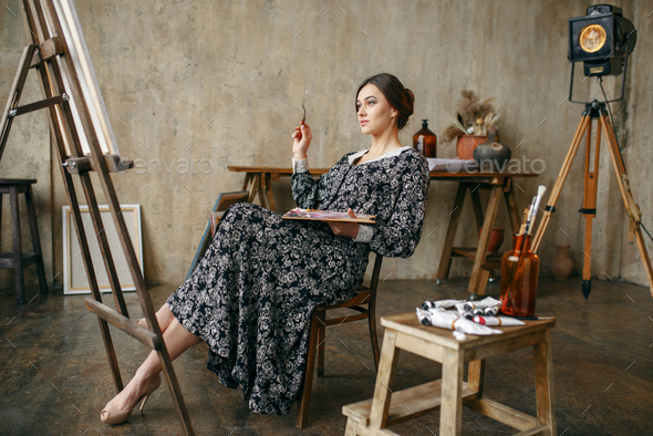 Female Painter Sitting At The Easel In Art Studio Stock Photo By NomadSoul