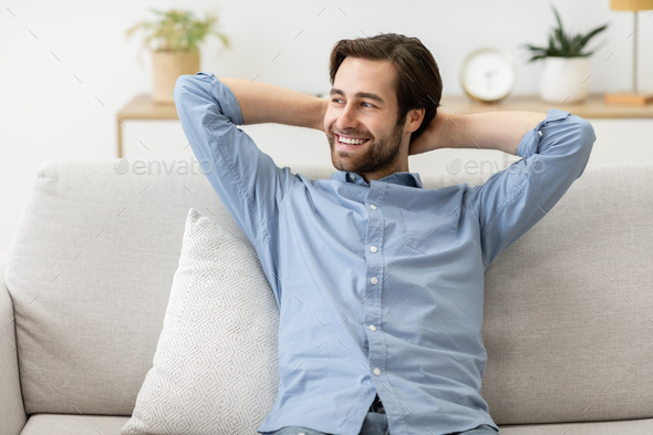 Happy Relaxed Man Sitting On Sofa At Home On Weekend Stock Photo By