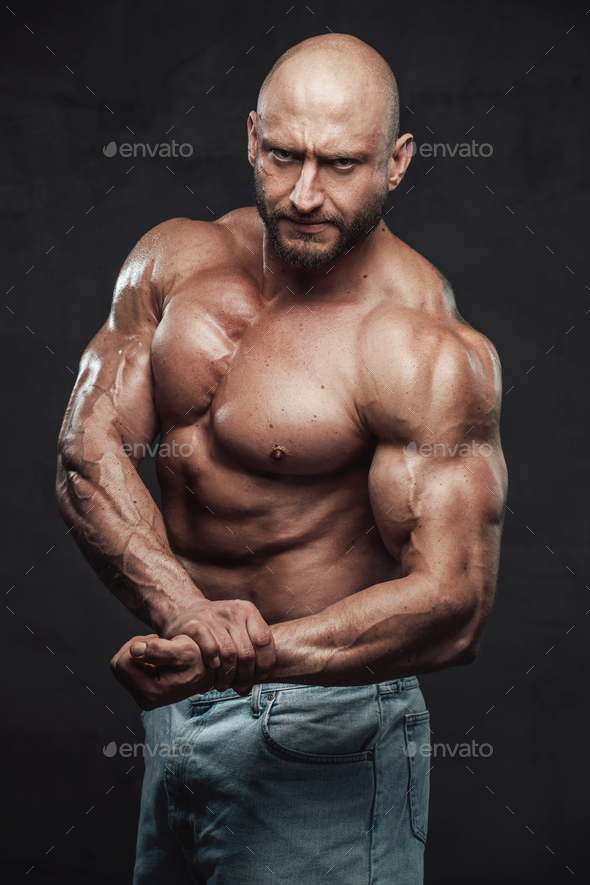 Naked And Strong Man With Bald Head Posing In Dark Background Stock