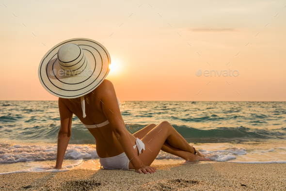 Woman In Bikini And Straw Hat On The Beach Stock Photo By Netfalls