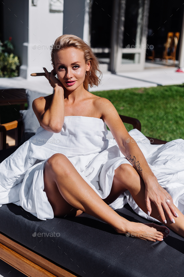 Fashion Outdoor Portrait Of Naked Woman Sit On Sofa Cover Herself With