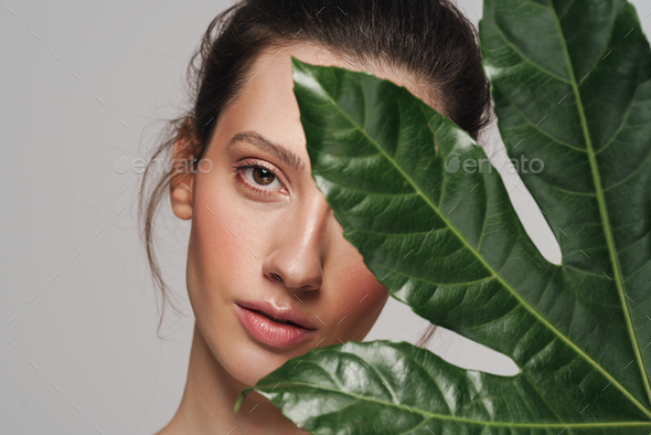 Beautiful Half Naked Woman Posing With Green Leaf On Camera Stock Photo