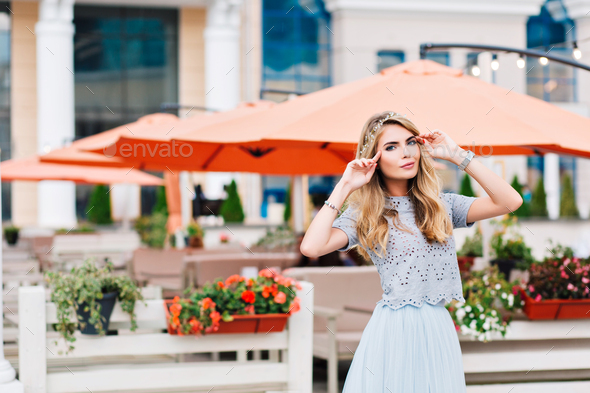 Beautiful Blonde Girl In Blue Tulle Skirt Is Walking On Terrace