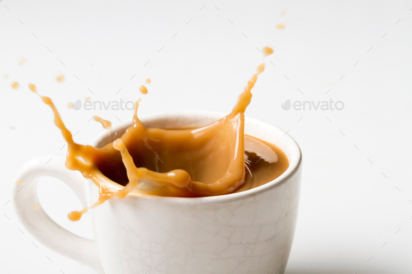 Cup Of Splashing Coffee On White Background Stock Photo By