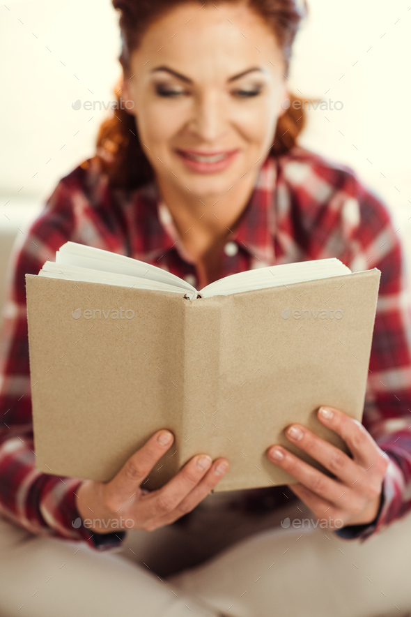 Close Up View Of Smiling Mature Woman Reading Book Stock Photo By