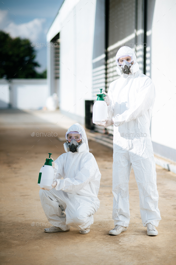 Disinfection Specialist Team In Ppe Suit Performing Public