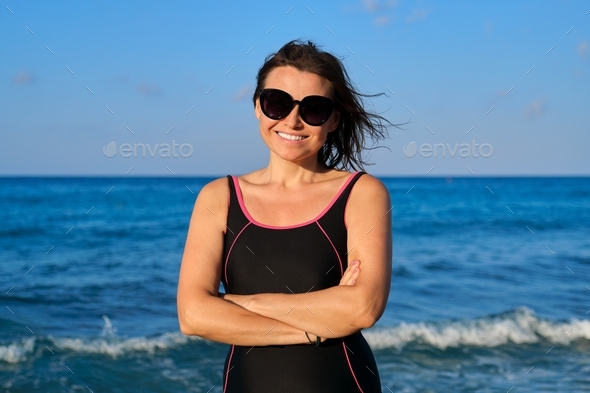 Portrait Of Beautiful Mature Woman In Sunglasses Swimsuit Smiling