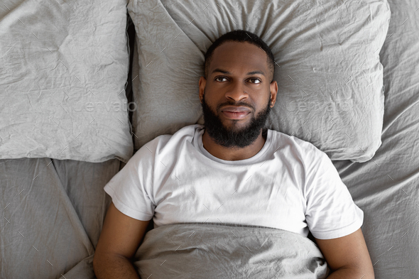 Black Man Lying In Bed And Thinking Top View Stock Photo By Prostock