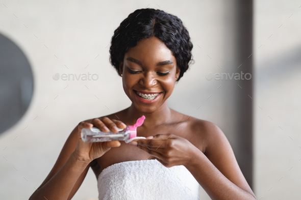 Smiling Black Woman Using Micellar Water And Cotton Pad Stock Photo By