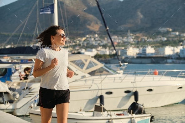 Smiling Mature Woman Running Jogging At Promenade Stock Photo By