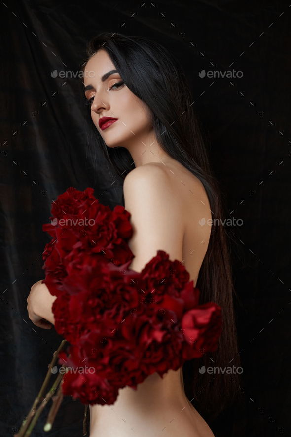 Beautiful Brunette Woman With A Bouquet Of Red Rose Flowers In Red