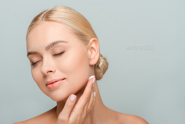 Happy Naked Woman Applying Face Cream Isolated On Grey Stock Photo By