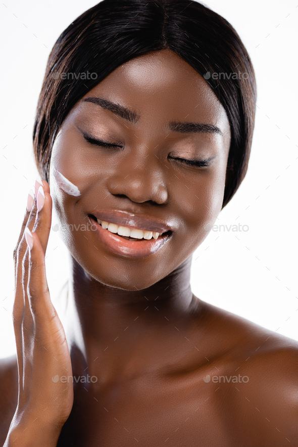African American Naked Woman With Closed Eyes Applying Cosmetic Cream