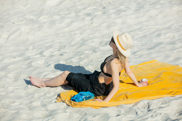 Woman Sits On Beach In Bikini And Realx Stock Photo By Masson Simon