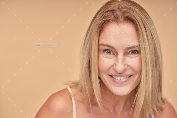 Portrait Of Beautiful Mature Woman Smiling At Camera While Posing In