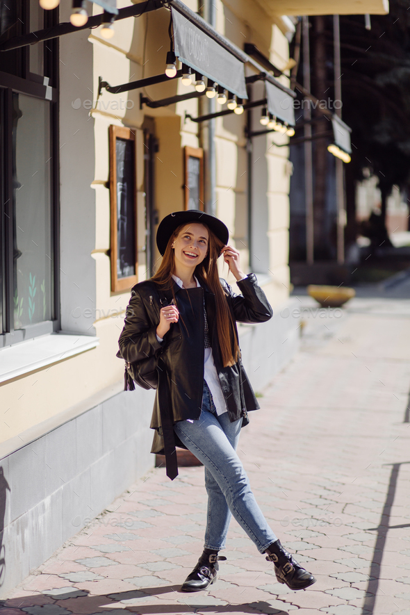 Íoung pretty girl walks around the city smiling and posing Stock Photo