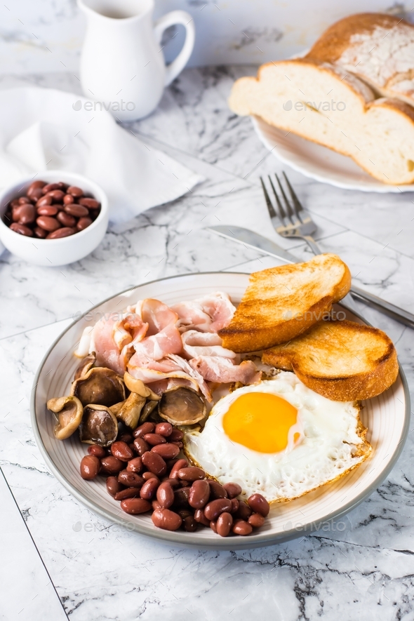 English Breakfast With Fried Egg Bacon Beans Mushrooms And Toast On