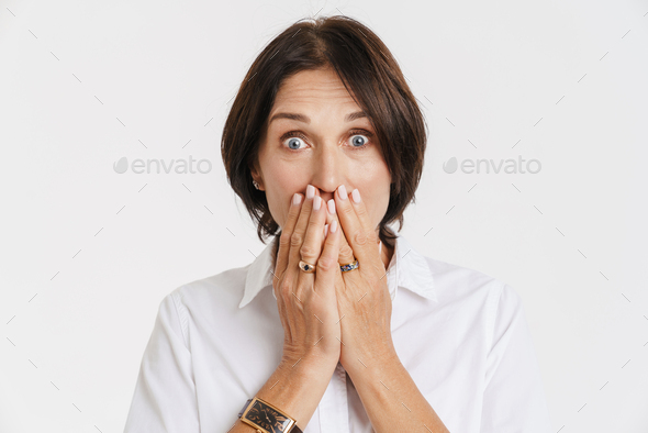 Mature Brunette Woman Expressing Surprise While Covering Her Mouth