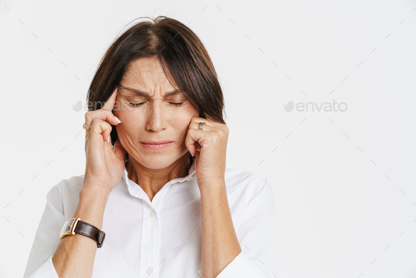 Mature Woman With Headache Frowning While Rubbing Her Temples Stock