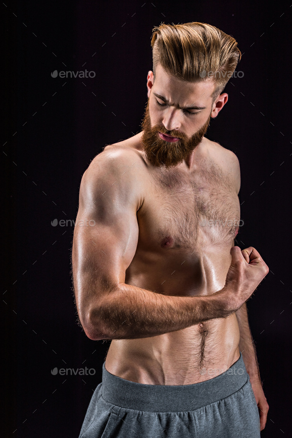 Shirtless Bearded Bodybuilder Posing Isolated On Black In Studio Stock