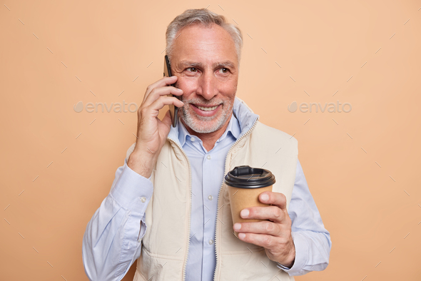 Handsome Bearded Mature Man Has Telephone Conversation With Colleague