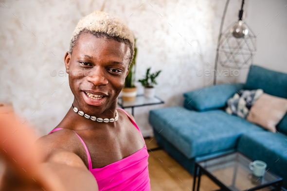 Joyful Black Transsexual Woman Showing Her Apartment To Camera Stock