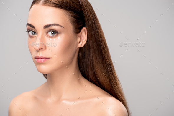 Attractive Nude Girl With Eye Cream On Face Isolated On Grey Stock