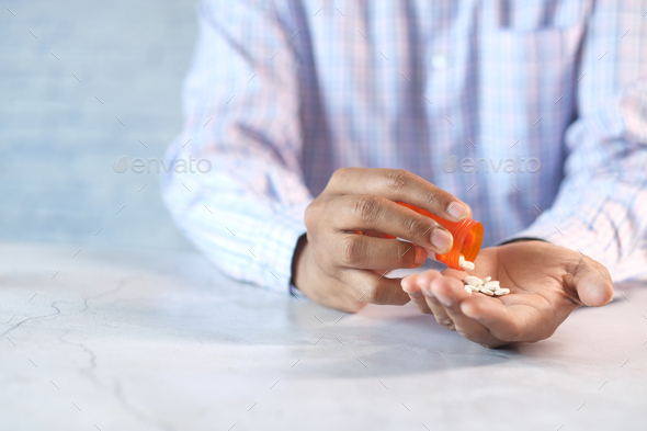 Man S Hand With Medicine Spilled Out Of The Pill Container Stock Photo