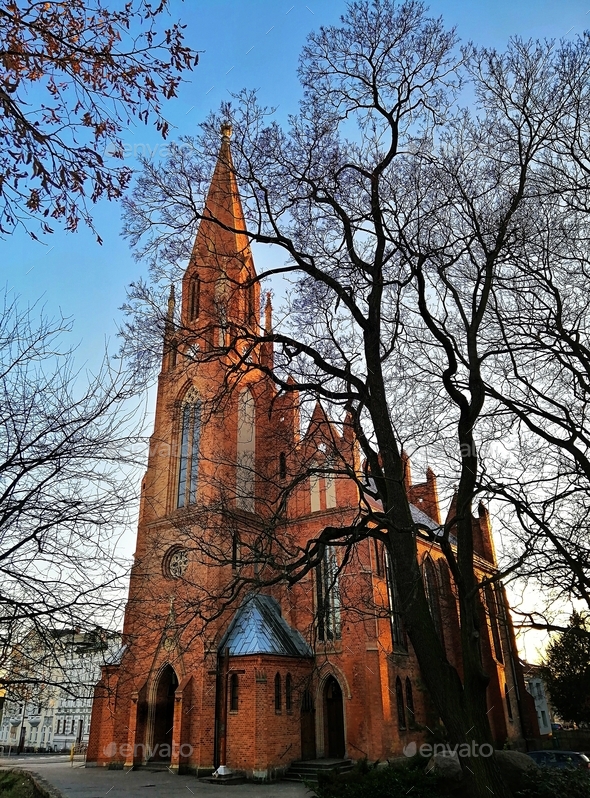 Vertical Shot Naked Tree Silhouettes And Heilig Geist Kirche In The