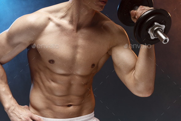 Naked Man Lifting Dumbbell Against Black Background Strong People