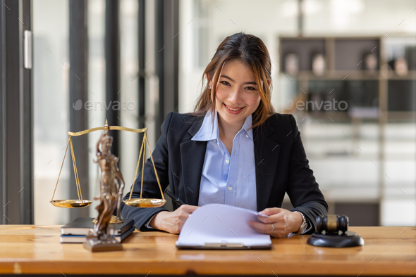 Business Asian Woman In Suit And Lawyer Working On A Documents At