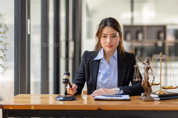 Business Asian Woman In Suit And Lawyer Working On A Documents At