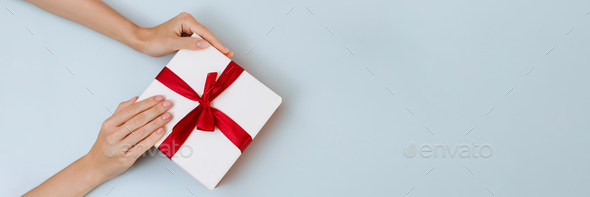 Banner Women S Hands Hold A White With A Red Ribbon Bow Stock Photo By