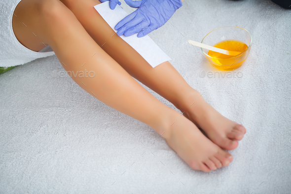 Waxing Beautician Waxing Woman S Leg In Spa Salon Stock Photo By Maksymiv