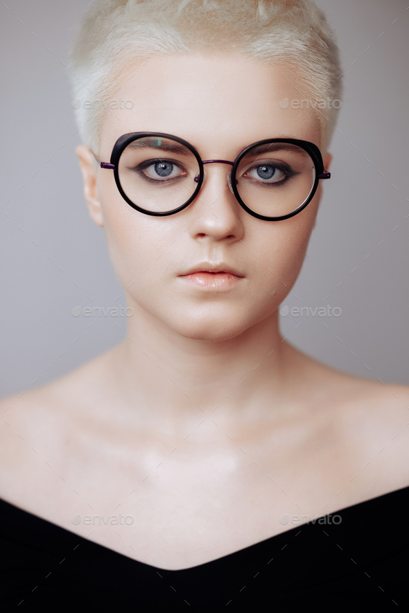 Portrait Of A Beautiful Blonde Woman With A Short Haircut On A White