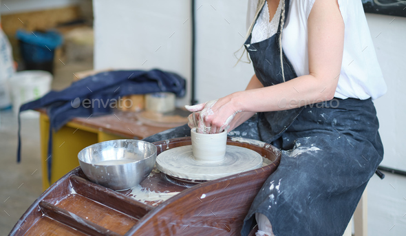 Female Make Dishes From Clay Woman Hands Working On Potters Wheel