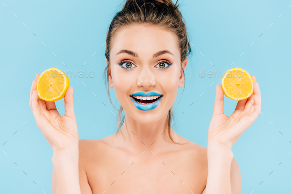 Excited Naked Beautiful Woman With Blue Lips Holding Orange Halves