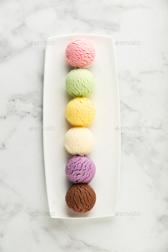 Set Of Various Ice Cream Scoops On White Marble Background Top View