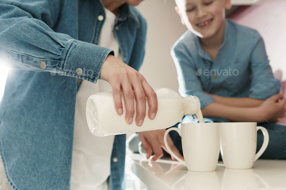 Mother And Her Cute Son Drinking Milk On The Kitchen Stock Photo By