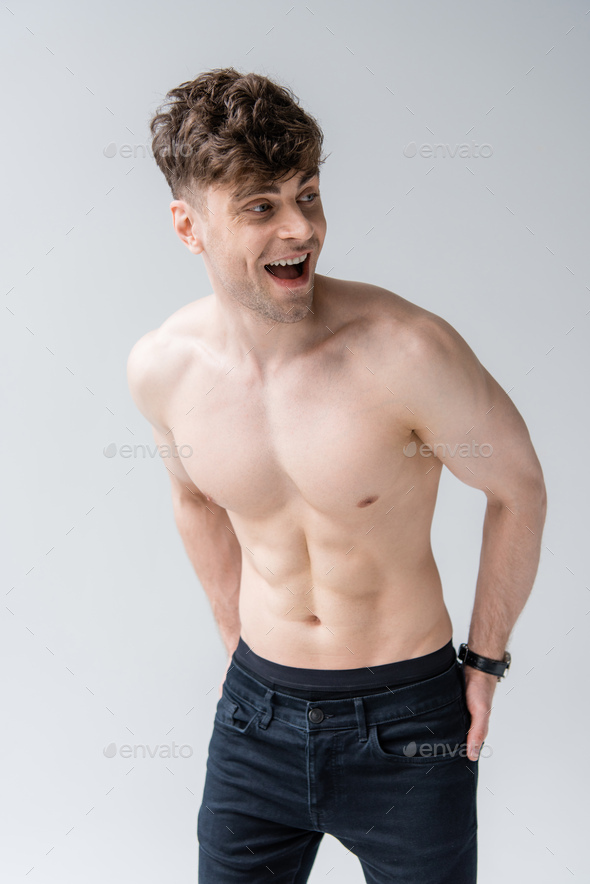 Laughing Shirtless Muscular Man Looking Away Isolated On Grey Stock