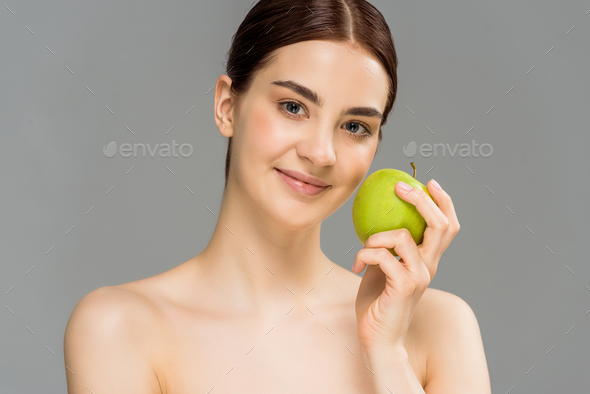 Happy Naked Woman Smiling While Holding Green Apple Isolated On Grey