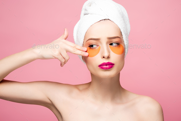 Naked Girl Touching Face With Eye Patches Isolated On Pink Stock Photo