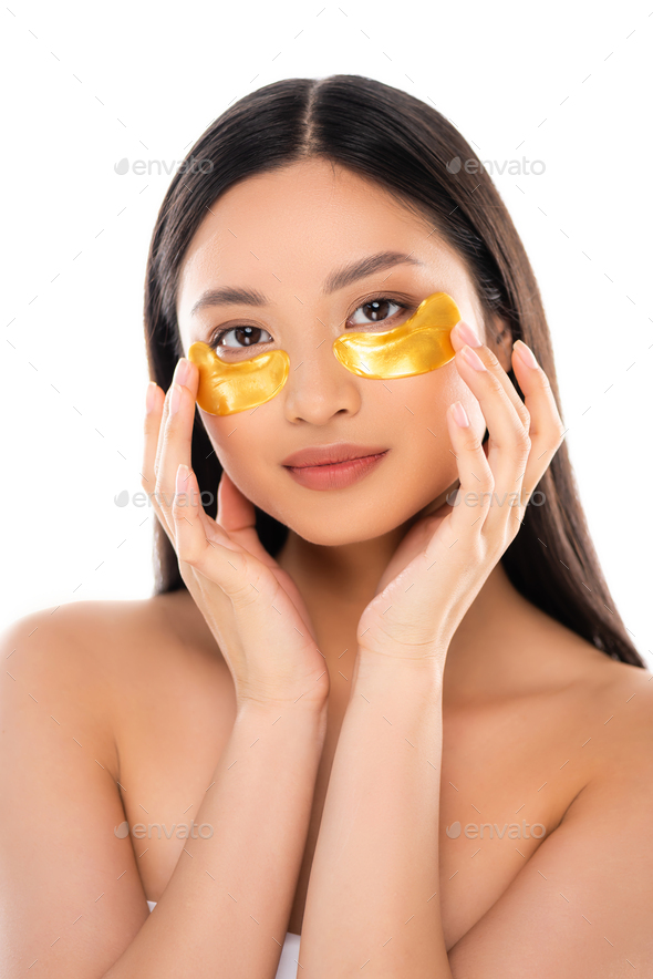 Brunette Asian Woman Looking At Camera While Touching Golden Eye