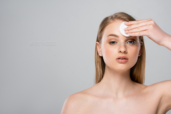 Pretty Woman With Bare Shoulders Removing Makeup With Cotton Pad